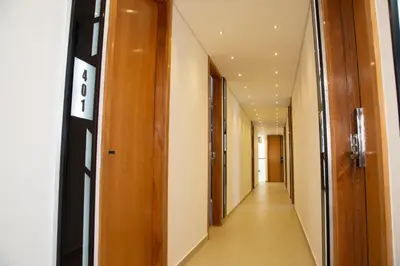 a corridor in a building with wooden doors at Hotel Silver Guarne in Guarne