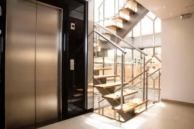 a spiral staircase in a room with a glass wall at Hotel Silver Guarne in Guarne