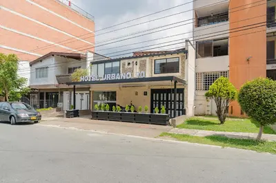 a building on a street with a car parked in front at Hotel Urbano 70 in Medellín