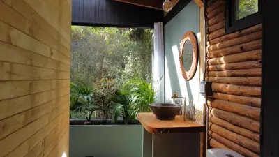 a bathroom with a window and a bowl on a counter at Glamping con jacuzzi cerca a Medellin in Guarne