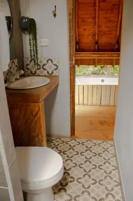 a bathroom with a toilet and a sink and a tub at Glamping con jacuzzi cerca a Medellin in Guarne
