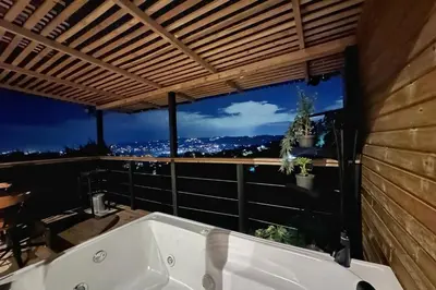 a bath tub in a bathroom with a view at Glamping con jacuzzi cerca a Medellin in Guarne