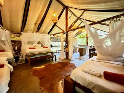a bedroom with two beds in a tent at Ecocabaña Pocahontas en rio Santo Domingo, Melcocho in Cocorná