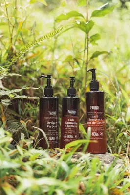 a group of three shampoo bottles sitting in the grass at Ecocabaña Pocahontas en rio Santo Domingo, Melcocho in Cocorná