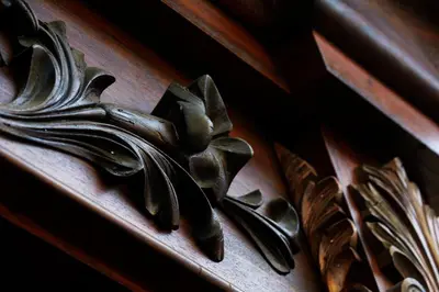 a wooden door with a carving of a flower on it at Hospedaje Casa Real in Salamina