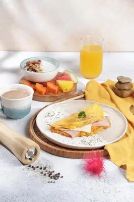 a table with a plate of food and a glass of orange juice at Palagua Lodge in San Rafael