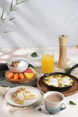 a table with plates of food and a glass of orange juice at Palagua Lodge in San Rafael