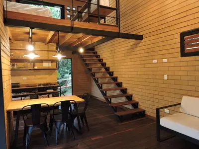 a staircase in a room with a table and chairs at Palagua Lodge in San Rafael