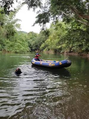 a man and a dog in a raft on a river at Paraíso Escondido Cabañas, Reserva Rio Claro, San Luis-Doradal in San Luis