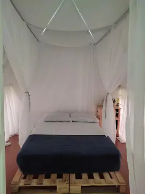 a bedroom with a bed in a tent at Paraíso Escondido Cabañas, Reserva Rio Claro, San Luis-Doradal in San Luis