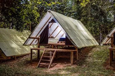 a tent sitting on a table with a ladder at Paraíso Escondido Cabañas, Reserva Rio Claro, San Luis-Doradal in San Luis