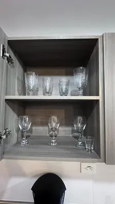a row of wine glasses sitting on a shelf at APTO AMOBLADO 77 mt2 in Itagüí