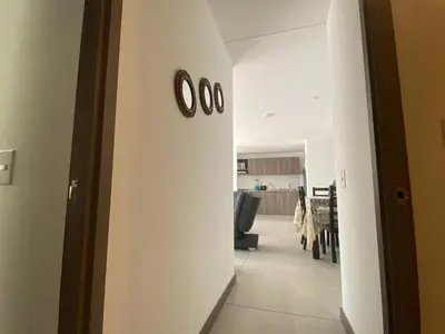 an office hallway with a clock on the wall at APTO AMOBLADO 77 mt2 in Itagüí