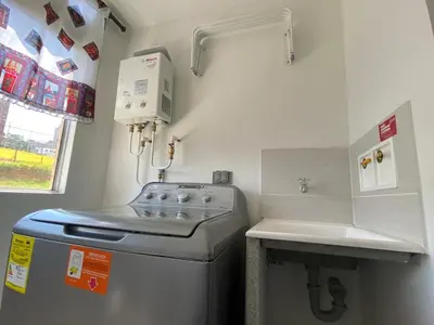 a small kitchen with a stove and a sink at APTO AMOBLADO 77 mt2 in Itagüí