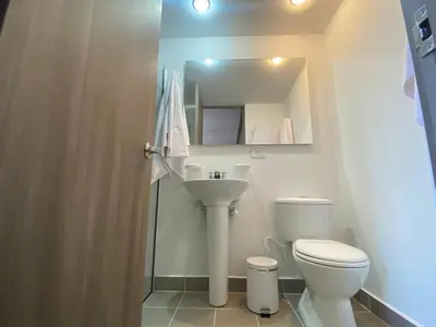 a small bathroom with a toilet and a sink at APTO AMOBLADO 77 mt2 in Itagüí