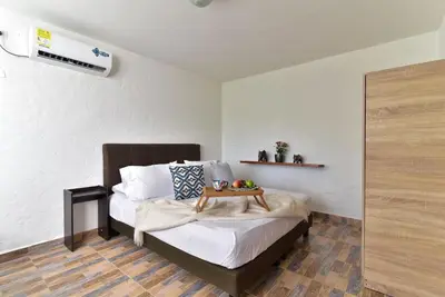 a bedroom with a bed with a tray of fruit on it at CABAÑAS LA DORADA in Doradal