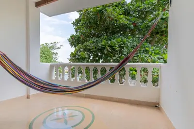 a hammock in a room with a window at CABAÑAS LA DORADA in Doradal