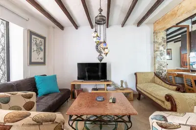 a living room with a couch and a table at CABAÑAS LA DORADA in Doradal