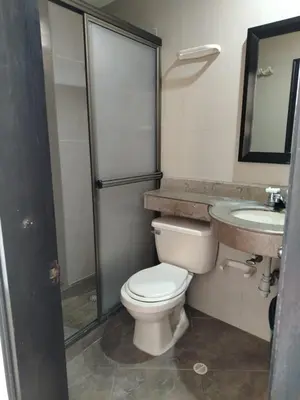 a bathroom with a toilet and a sink at Hotel Country Medellin in Medellín