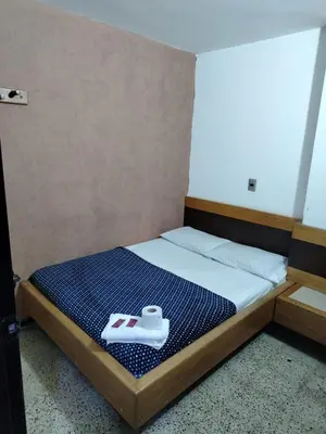 a bedroom with a bed with a tray of food on it at Hotel Country Medellin in Medellín