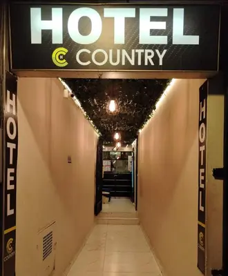 a hotel county sign hanging over a hallway at Hotel Country Medellin in Medellín