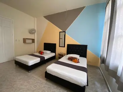 a room with two beds in a room at HOTEL CALLE REAL SUITE in Medellín