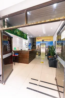 a lobby of a fast food restaurant with a counter at HOTEL CALLE REAL SUITE in Medellín