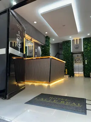 a lobby of a store with a counter and a rug at HOTEL CALLE REAL SUITE in Medellín