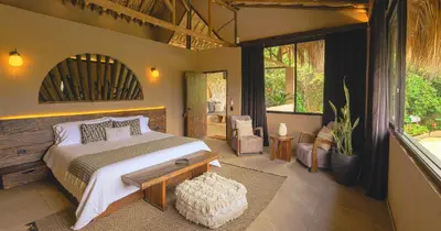 a bedroom with a large bed and a large window at Hotel Casa Candela in San Jerónimo