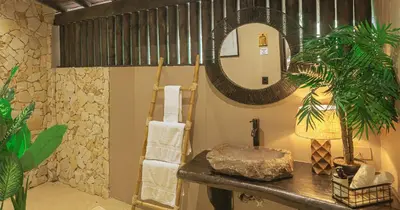 a bathroom with a sink and a mirror on a counter at Hotel Casa Candela in San Jerónimo