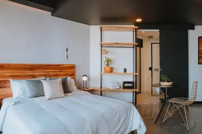 a bedroom with a bed and a table and chairs at Hotel 3450 Living Lofts in Medellín