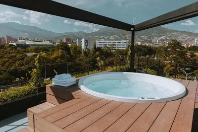 a hot tub on a deck with a view of a city at Hotel 3450 Living Lofts in Medellín
