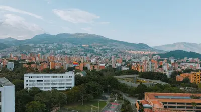 a view of a city with buildings and mountains at Hotel 3450 Living Lofts in Medellín