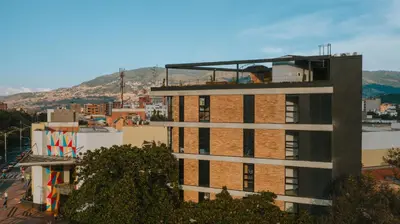 a tall building with a balcony on top of it at Hotel 3450 Living Lofts in Medellín