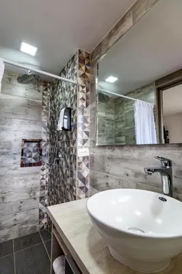 a bathroom with a sink and a mirror at Hotel Cabo de la Vela Medellin in Medellín