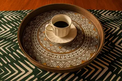 a cup of coffee on a plate on a table at La Casa de Ana in Jardin