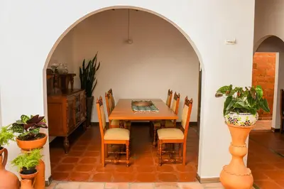 a dining room with a table and some plants at La Casa de Ana in Jardin