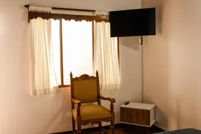a chair sitting in a room with a window at La Casa de Ana in Jardin