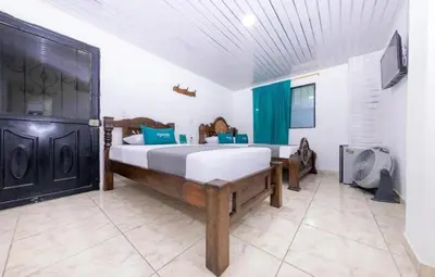 a bedroom with a large bed in a room at Hotel Vegas Sergio in Medellín