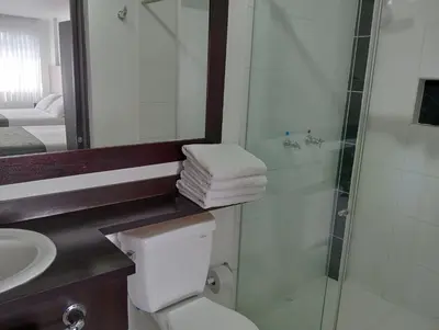 a bathroom with a shower and a toilet and a sink at Europa Hotel Boutique Manizales in Manizales
