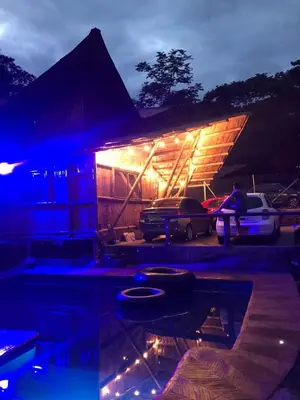 a house with a pool in front of it at night at hermosa cabaña villa majo, cuenta con el espectacular rio santo domingo in San Francisco
