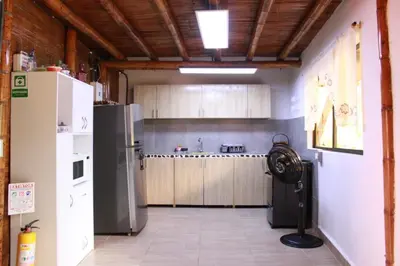 a kitchen with a refrigerator and a stove at hermosa cabaña villa majo, cuenta con el espectacular rio santo domingo in San Francisco