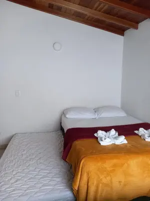a bed with two white towels on top of it at vista piedra in Guatapé