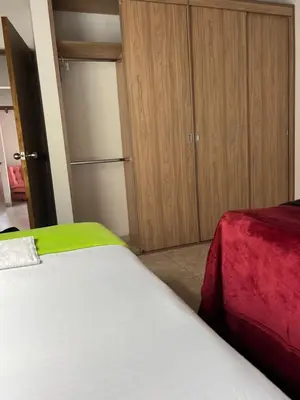 a bedroom with a bed and a cupboard with a door at vista piedra in Guatapé