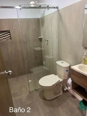 a bathroom with a shower and a toilet and a sink at vista piedra in Guatapé