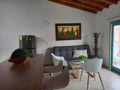 a living room with a couch and a table at vista piedra in Guatapé
