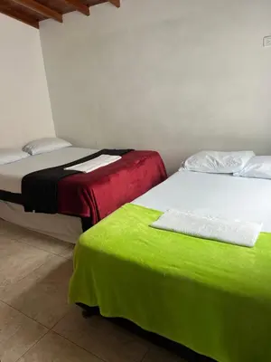 two beds sitting next to each other in a room at vista piedra in Guatapé