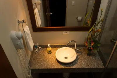 a bathroom counter with a sink and a mirror at Hotel Casa Galvez in Manizales