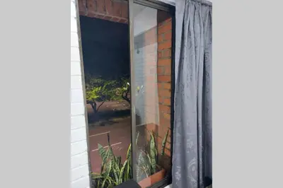 a window of a house with a curtain at Loft Poblado Park in Medellín