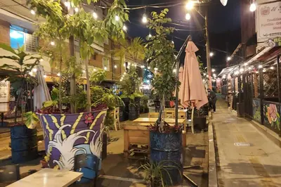 a street with potted plants and an umbrella at Loft Poblado Park in Medellín